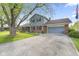 The exterior of a lovely two-story home with a wide driveway and attached garage at 7153 N Audubon Rd, Indianapolis, IN 46250