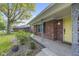 Charming front porch with brick accents, wrought iron details, and a bright yellow front door at 7153 N Audubon Rd, Indianapolis, IN 46250