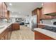 Spacious kitchen featuring stainless steel appliances, light wood floors, and ample counter space at 7153 N Audubon Rd, Indianapolis, IN 46250