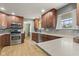 Well-lit kitchen equipped with modern appliances, granite countertops, and wooden cabinetry at 7153 N Audubon Rd, Indianapolis, IN 46250