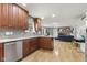 Open-concept kitchen with stainless steel appliances, abundant counter space, and wood floors at 7153 N Audubon Rd, Indianapolis, IN 46250