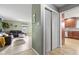 View from the hallway of the living room that features an olive green wall and a brown leather sofa at 7153 N Audubon Rd, Indianapolis, IN 46250