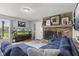Comfortable living room with a brick fireplace and large screen TV at 7153 N Audubon Rd, Indianapolis, IN 46250