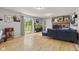 Bright living room with a sliding door to backyard, wood floors, fireplace, and stylish decor at 7153 N Audubon Rd, Indianapolis, IN 46250