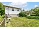 Well-maintained backyard with lush green lawn and mature landscaping provides a serene outdoor space at 7250 Hoover Rd, Indianapolis, IN 46260