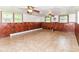 Large basement featuring paneled walls and tile flooring at 7250 Hoover Rd, Indianapolis, IN 46260