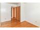 Simple bedroom featuring hardwood flooring and closet space at 7250 Hoover Rd, Indianapolis, IN 46260