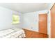 Bright bedroom with wood floors, closet, and natural light at 7250 Hoover Rd, Indianapolis, IN 46260