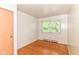 Cozy bedroom featuring gleaming hardwood floors, closet, and a window with natural light at 7250 Hoover Rd, Indianapolis, IN 46260