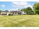 Charming two-story home with light brick and black shutters, situated on an expansive lawn at 7250 Hoover Rd, Indianapolis, IN 46260