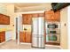 Bright kitchen with stainless steel refrigerator and built-in microwave and oven at 7250 Hoover Rd, Indianapolis, IN 46260