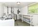 Laundry room featuring a washer-dryer, storage shelving and window at 7250 Hoover Rd, Indianapolis, IN 46260