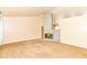 Spacious living room with a brick fireplace, and neutral carpet at 7250 Hoover Rd, Indianapolis, IN 46260