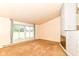 Bright living room with a stone fireplace and large window at 7250 Hoover Rd, Indianapolis, IN 46260