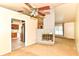 Open-concept living room with a unique brick fireplace and a view into the kitchen at 7250 Hoover Rd, Indianapolis, IN 46260