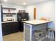 Bar area with counter seating, dark cabinets, and custom decor at 7897 Hickory Ridge Ln, Mooresville, IN 46158
