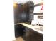 Custom wet bar featuring dark cabinets, unique backsplash, and ample counter space at 7897 Hickory Ridge Ln, Mooresville, IN 46158