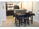 Bar and dining area with dark cabinets, bar seating, and dining table at 7897 Hickory Ridge Ln, Mooresville, IN 46158