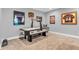 Finished basement boasts an air hockey table and sports memorabilia for endless hours of fun and entertainment at 7897 Hickory Ridge Ln, Mooresville, IN 46158
