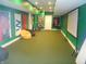 Finished basement featuring a projector screen, bright green walls, and racing decor at 7897 Hickory Ridge Ln, Mooresville, IN 46158