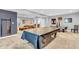 Spacious finished basement offers a pool table, air hockey, and living area perfect for entertaining guests at 7897 Hickory Ridge Ln, Mooresville, IN 46158