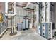 Unfinished basement with exposed pipes, water softener, and furnace at 7897 Hickory Ridge Ln, Mooresville, IN 46158