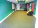 Finished basement with bright green walls, beanbag chairs, and racing decorations at 7897 Hickory Ridge Ln, Mooresville, IN 46158