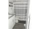 Bathroom features a white vanity, toilet and grey and white striped shower curtain at 7897 Hickory Ridge Ln, Mooresville, IN 46158