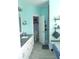 Bright bathroom with modern vanity, walk in closet and shower/tub with decorative shelving at 7897 Hickory Ridge Ln, Mooresville, IN 46158