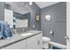 Modern bathroom with a gray wall, gray countertop, towel, mirror, toilet, and shower at 7897 Hickory Ridge Ln, Mooresville, IN 46158