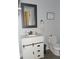 Updated bathroom with a white vanity, gray framed mirror, and modern fixtures at 7897 Hickory Ridge Ln, Mooresville, IN 46158