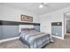 Comfortable bedroom with a striped bedding, white ceiling fan, and view to the hallway at 7897 Hickory Ridge Ln, Mooresville, IN 46158