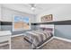 Cozy bedroom with a white bed, striped bedding, and window with a view of the outdoors at 7897 Hickory Ridge Ln, Mooresville, IN 46158