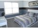 Bright bedroom with large window, neutral paint, and plush patterned comforter at 7897 Hickory Ridge Ln, Mooresville, IN 46158