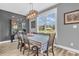 Cozy dining room with window views, checkered tablecloth and cabinet provides a homey space at 7897 Hickory Ridge Ln, Mooresville, IN 46158