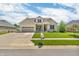 Beautifully maintained brick home with an attached garage, lush lawn, and inviting front porch at 7897 Hickory Ridge Ln, Mooresville, IN 46158