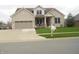 Charming two-story home with a brick exterior, attached garage, well-manicured lawn, and inviting front porch at 7897 Hickory Ridge Ln, Mooresville, IN 46158