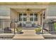 Welcoming front porch with seating and decorative potted flowers at 7897 Hickory Ridge Ln, Mooresville, IN 46158