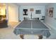 Open game room featuring ping pong table, air hockey, and lounge area at 7897 Hickory Ridge Ln, Mooresville, IN 46158