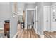 Hallway with hardwood floors, access to stairs and views of the living room at 7897 Hickory Ridge Ln, Mooresville, IN 46158
