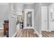 Hallway with hardwood floors that offer views into the living and bathroom areas at 7897 Hickory Ridge Ln, Mooresville, IN 46158