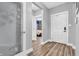 Bright hallway with wood floors and decorative glass door leading into the bedroom at 7897 Hickory Ridge Ln, Mooresville, IN 46158