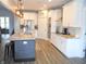 Well-lit kitchen with stainless steel appliances, granite countertops, large island, and pendant lighting at 7897 Hickory Ridge Ln, Mooresville, IN 46158
