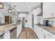 Bright kitchen with granite counters, stainless appliances, and white cabinets offer a modern cooking space at 7897 Hickory Ridge Ln, Mooresville, IN 46158