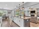Eat-in kitchen features granite island, modern appliances, and connects to dining area with natural light at 7897 Hickory Ridge Ln, Mooresville, IN 46158