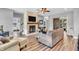 Inviting living room featuring a stone fireplace, modern furniture, and lots of natural light at 7897 Hickory Ridge Ln, Mooresville, IN 46158
