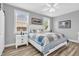 Bright main bedroom offers windows with blinds and a stylish ceiling fan for comfort at 7897 Hickory Ridge Ln, Mooresville, IN 46158