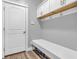 Mudroom offers bench and hooks, storage above the door, and adjacent to a convenient interior door at 7897 Hickory Ridge Ln, Mooresville, IN 46158