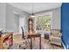 Bright office space with a wooden desk, grandfather clock, and chair by a window at 7897 Hickory Ridge Ln, Mooresville, IN 46158