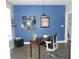 Home office with a blue accent wall, hardwood floors, a desk and chair, and ample natural light at 7897 Hickory Ridge Ln, Mooresville, IN 46158